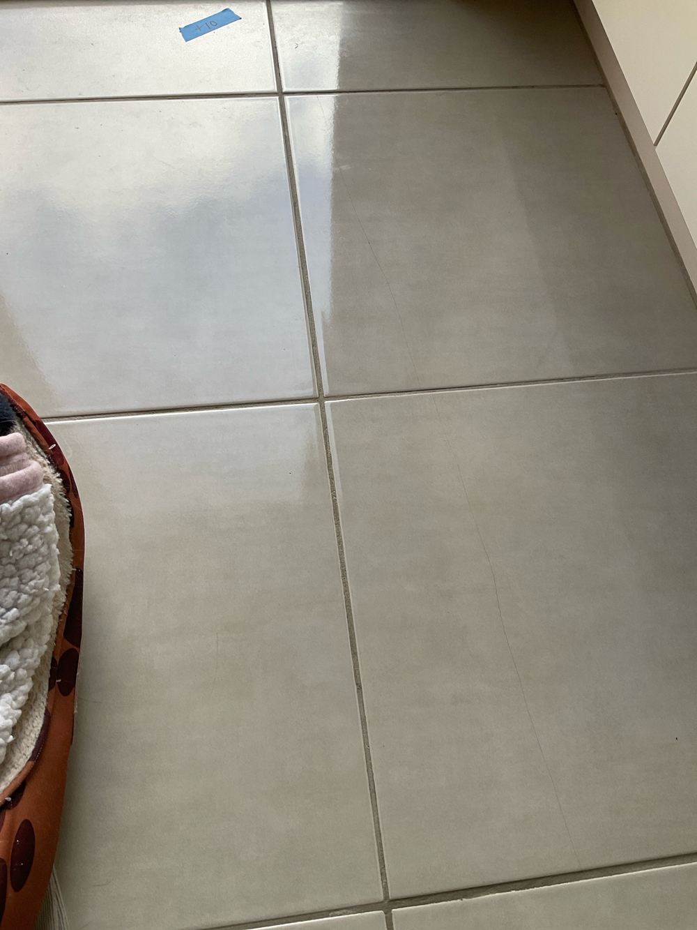 Laundry floor tiles cracking because they had no room to move, Werribee