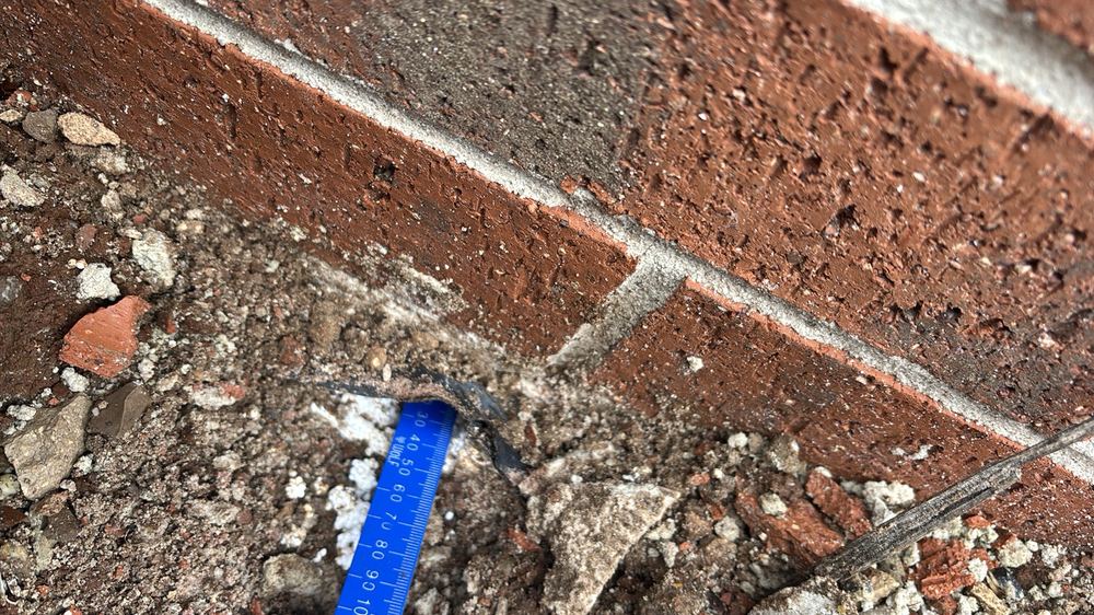 Brickwork projecting more than 15mm past the edge of the slab, found during a pre-handover inspection in Werribee