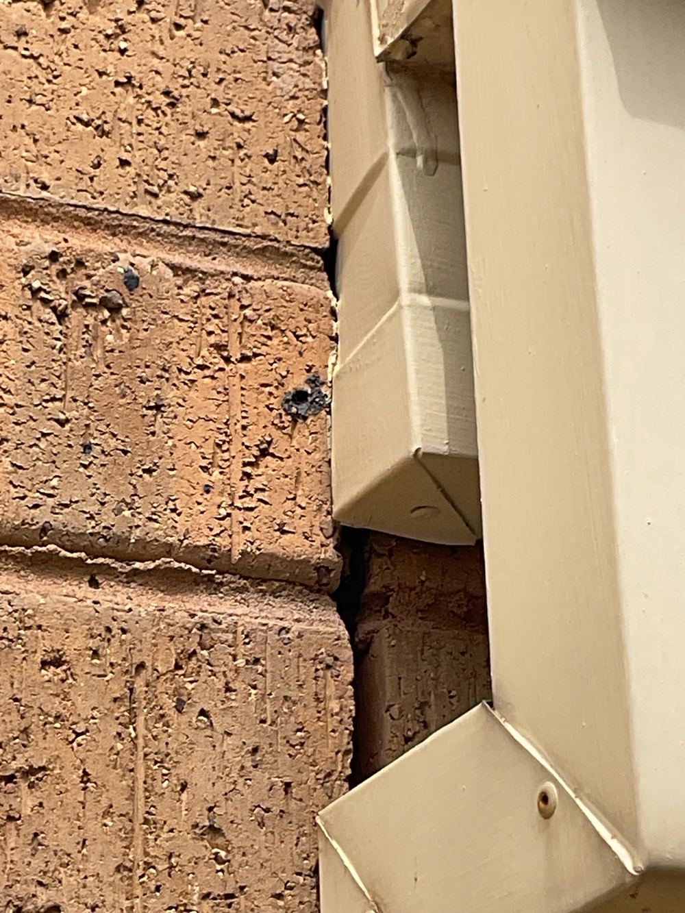Open gaps in the brick veneer letting in moisture and pests, Sunshine North, Werribee