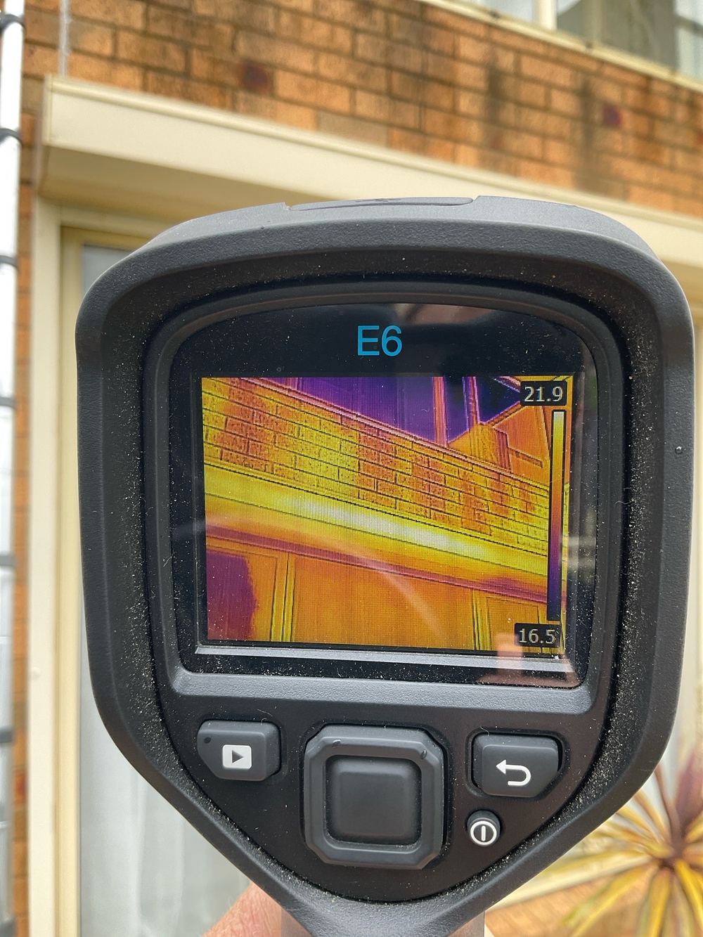 Thermal check of stained brickwork beneath a balcony, found during a building and pest inspection in Sunshine North