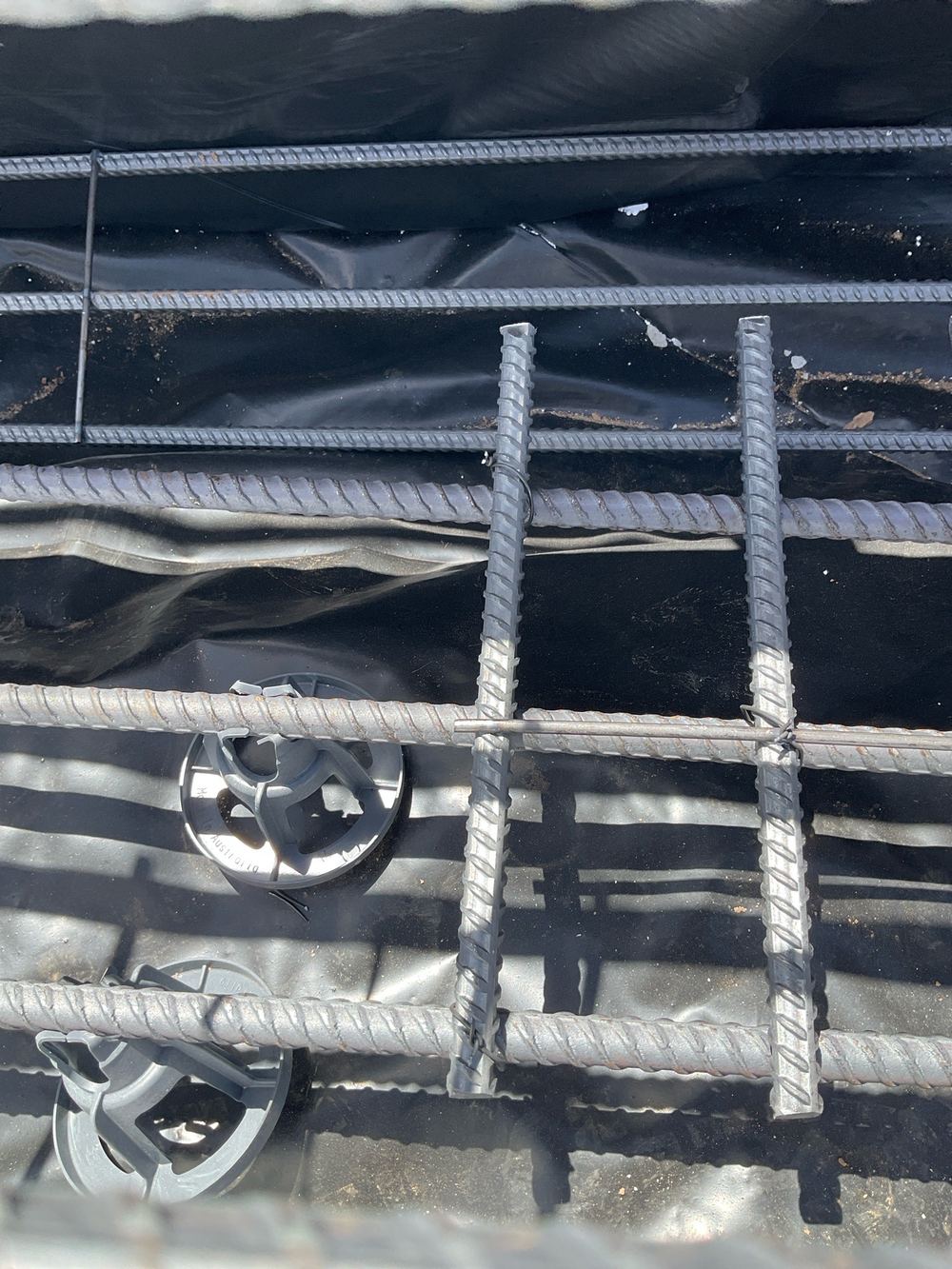 Garage edge beam mesh laid apart instead of stacked as the drawings detail, found during a slab pre-pour inspection in Werribee